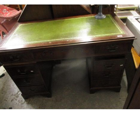 A modern mahogany, twin pedestal, eight drawer desk, on bracket feet 