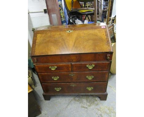 A Georgian walnut bureau, the fall flap revealing a fitted interior of pigeonholes and drawers a with sliding compartment to 