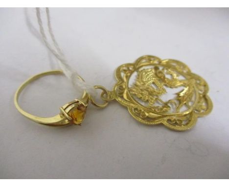 A 14ct gold ring and a gold coloured pendant 