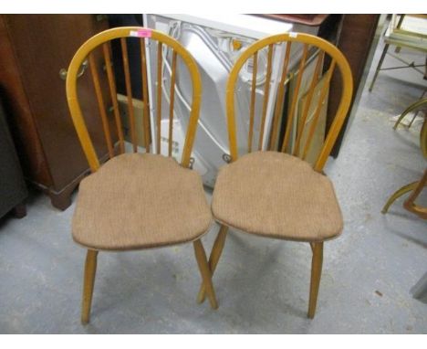 A pair of Ercol stick back chairs 