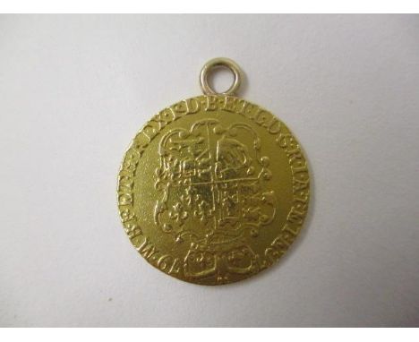 A George III gold guinea 1779 with a suspension ring, 8.5g 