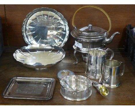 A collection of plated ware including a spirit kettle with stand, two tankards, a pair of dishes, a tray, silver tea caddy sp