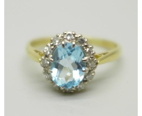 An 18ct gold, blue topaz and diamond cluster ring, 3.7g, R 