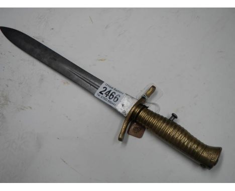 An early 29th century bayonet in scabbard with ribbed brass hilt, blade 30 cm.Hilt round with number 21 stamped next it