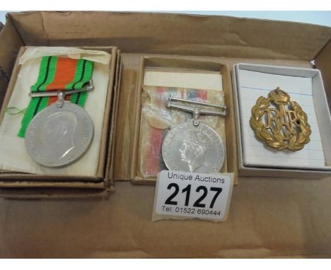 Two WW2 medals for Kenneth Foster and R J Mawer together with an RAF cap badge belonging to 1135011 Cpl E W Gandy.