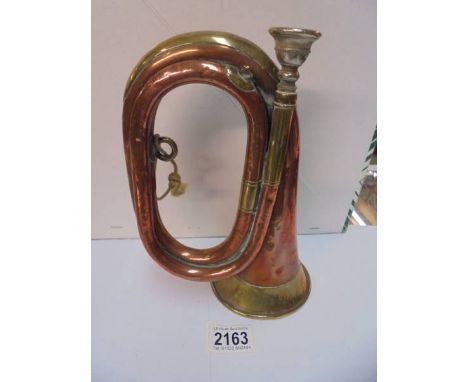 A brass and copper bugle..