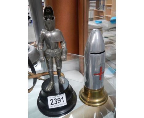 A lighter in the shape of a knight in armour and a money box in the shape of a 1914-18 bullet.