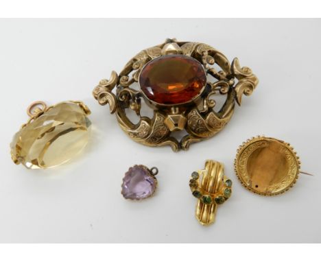 A 9ct gold citrine fob seal, a yellow metal brooch set with green gems, a yellow metal amethyst heart pendant and a large cit