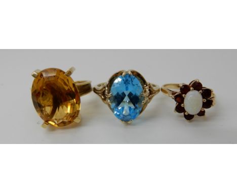 An 18ct retro citrine ring size O1/2, a 9ct gold blue topaz ring size V and a garnet and opal cluster ring size J1/2, combine