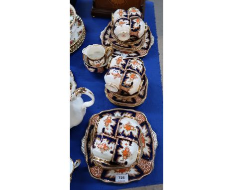 A Royal Albert tea set in Imari palette comprising twelve cups, saucers and plates, two cake plates, milk jug and sugar bowl 