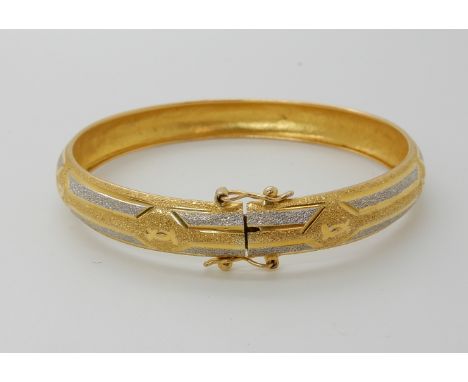 An 18ct gold bi-colour bangle, weight 10.8gms Condition Report: Available upon request