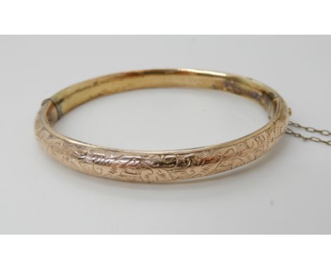 A 9ct gold engraved bangle, weight 8.4gms Condition Report: Available upon request
