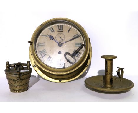 A brass circular bulkhead clock, graduated weights and candlestick Condition Report: Available upon request