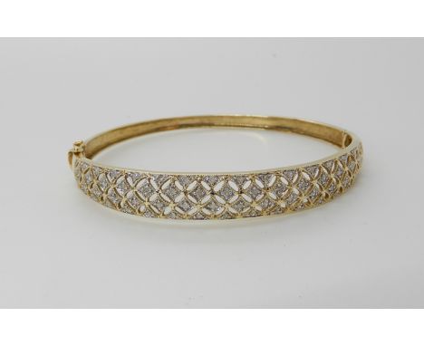 A 9ct gold diamond set pierced bangle, weight 8.8gms Condition Report: Available upon request