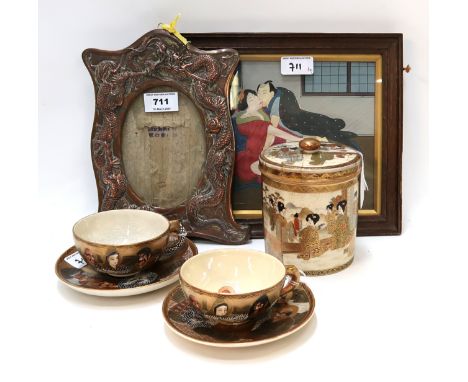 A pair of Satsuma cups and saucers, a pot and cover, a dragon decorated frame and an erotic picture Condition Report: Availab