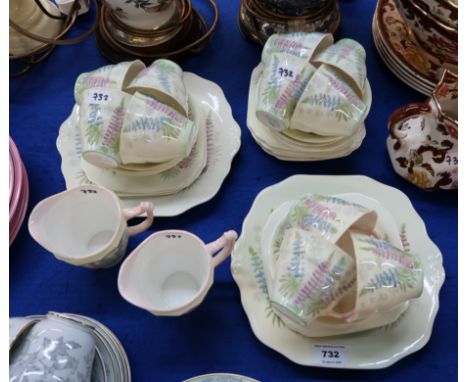 An Old Royal Bone China teaset decorated with lupins comprising twelve cups, saucers and plates, two cake plates and two milk