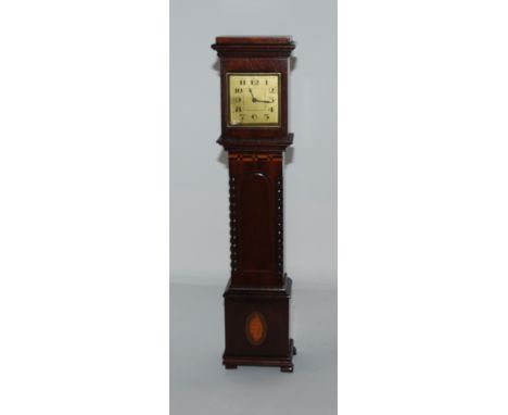 An ebony carved desk stand with elephants, miniature long case clock, hand bell and preserved lizard in glass jar (4) Conditi