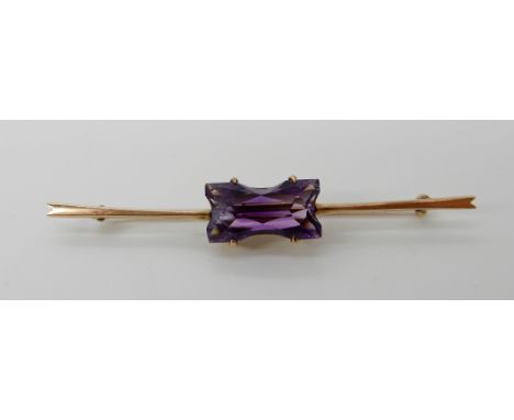 A 9ct gold brooch set with an unusual cut amethyst, length 6cm, weight 3.3gms Condition Report: Available upon request