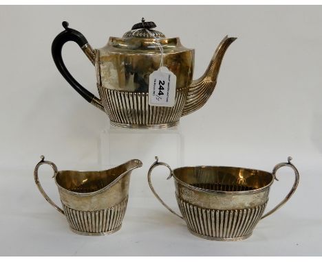 A three piece silver tea service with half ribbed body, Sheffield 1894, the teapot 14cm high (3), 664gms Condition Report: Av