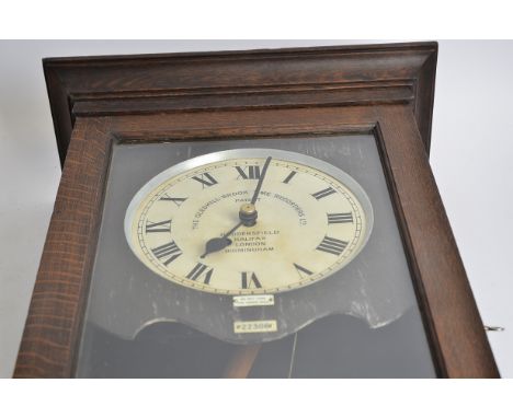 A Gledhill-Brook time recorders ltd clocking in clocking out patent clock,  in a wooden case, with enamel dial behind glass, 