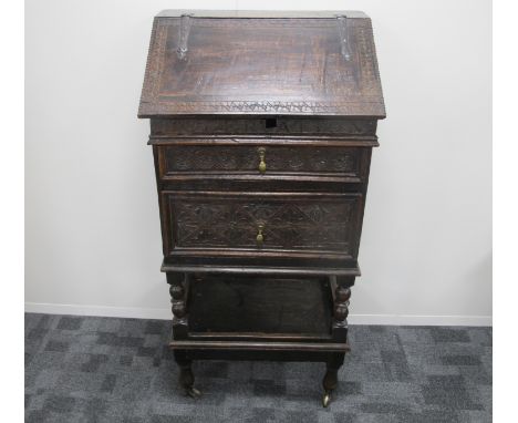 A antique oak bible box, of 18th century origin, the body being  heavily carved in floral designs, two drawers,  hinged risin