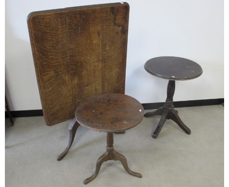 A antique oak rectangular tilt top table, three plank top with a moulded edge,  turned column and tripod base, sold together 