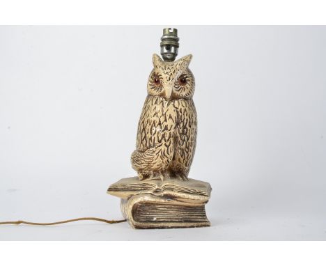 An early 20th Century plaster lamp base in the form on an owl, with orange glass eyes, height of base excluding any fixtures 