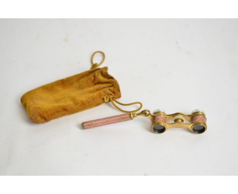 A pair of early 20th Century opera glasses,  with mother of pearl, pink guilloche enamel and gilt swags of flowers, in origin