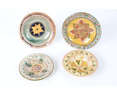 Della Robbia Pottery (Birkenhead 1894-1906), three small shallow earthenware dishes together with a small bowl, each with cen