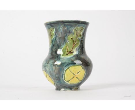 Della Robbia Pottery (Birkenhead 1894-1906),  a squat vase with flared rim and sgraffito decoration of leaves and flowers, he