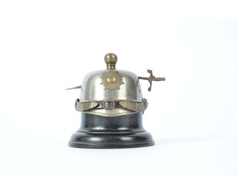 A late 19th Century French helmet inkwell,  with sword piercing through, height 8cm, a/f finial requires re-attaching
