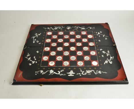 A 20th Century lacquered and mother of pearl Chinese chess and backgammon board,  63cm x 28cm x 15cm when closed