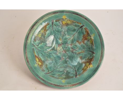 Della Robbia Pottery (Birkenhead 1894-1906), a deep sgraffito decorated earthenware bowl, the cavetto with creeping plant ten