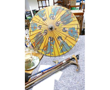 A collection of vintage walking sticks: banded item noted together with oriental parasol (some rips)