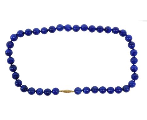 A 20thC lapis lazuli collar necklace, set with forty lapis round bead cut stones, and on a knotted string strand, with a 9ct 