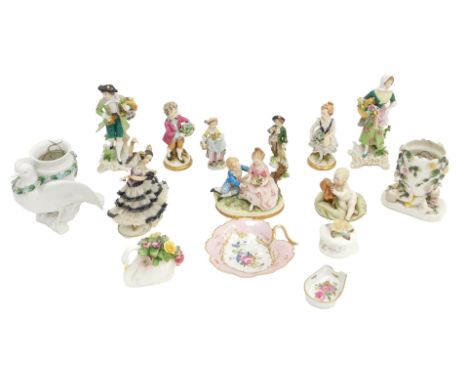 A pair of German porcelain figurines, each modelled in the form of a lady and gentleman holding a basket of flowers, gold anc