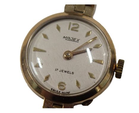A 9ct gold Majex lady's wristwatch, with a silvered numeric dial, on three bar bracelet, the dial 1.5cm diameter, 16g, in a J