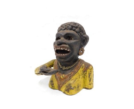 A cast iron money box, painted in black, orange and yellow, modelled in the form of a female figure with crooked arm, titled 
