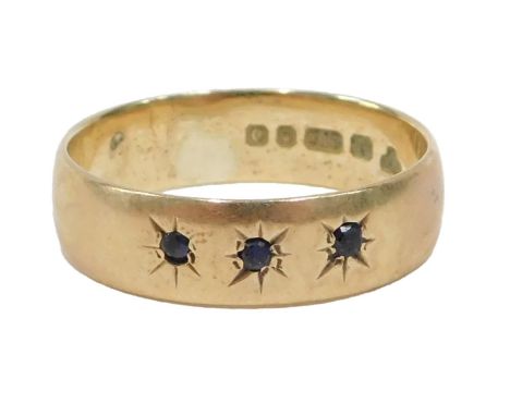 A 9ct gold dress ring, set with three star set sapphires, ring size I½, 2.1g all in.