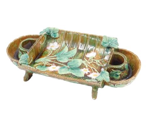 A 19thC Majolica strawberry dish or stand, decorated with strawberry plant flowers and leaves, on a stylised wooden ground, v