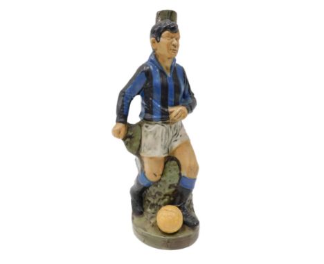 A novelty Italian Curaco decanter, modelled in the form of a football player wearing blue and black stripes, possibly Inter M