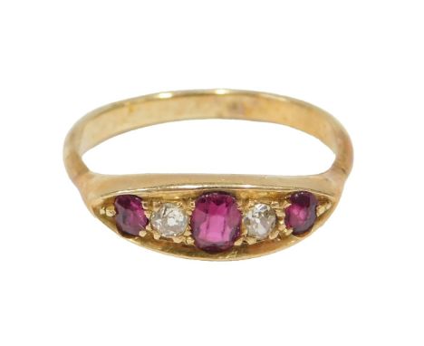 A ruby and diamond half hoop dress ring, set with three oval cut rubies, each claw set, and two tiny diamonds, on a yellow me