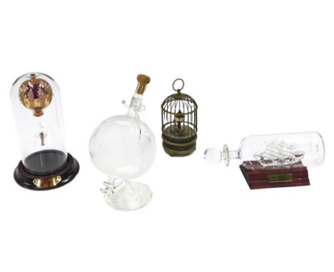 Miscellaneous trinkets, comprising a miniature globe decanter, USS Constitution glass ship in a bottle, glass hot air balloon