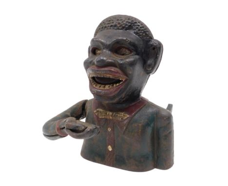 A painted ebonised money box, modelled in the form of a figure, stamped to reverse Jolly Bank, Pat. Mari. 48?2, 17cm high. No