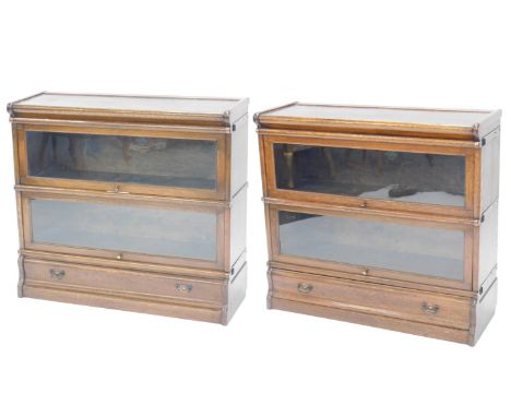 A pair of Globe Wernicke bookcases, both with shaped top, two glazed doors over single drawer base, 78cm high, 87cm wide.