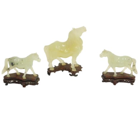 A Chinese jade coloured horse, and a pair of smaller examples, 14cm and 12cm high respectively. (AF)