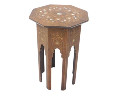 An early 20thC rosewood and marquetry Moorish style table, the octagonal top inlaid in mother of pearl, on faceted legs, with