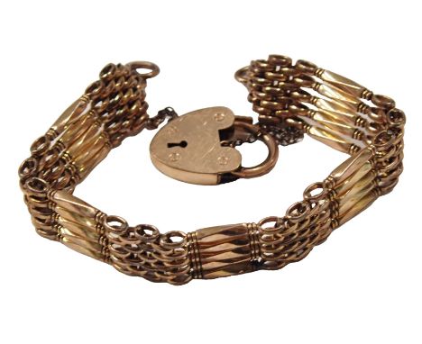 A 20thC gold plated gate bracelet, of five bar design, with safety chain and heart shaped padlock, 14cm long.