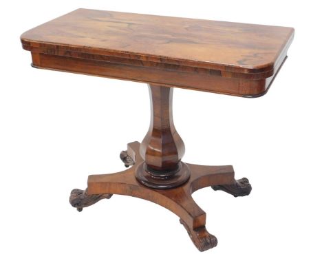 A William IV rosewood card table, the top with rounded corners, on a baluster column, concave platform and scroll legs, 92cm 