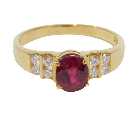 A 20thC ruby and diamond multi stone dress ring, set with oval cut ruby, 6.5mm x 5.5mm x 4.72mm, approx 1.52ct, flanked by fo
